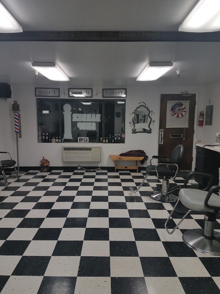 A classic barber chair and mirror station at Garrity Barber Shop
