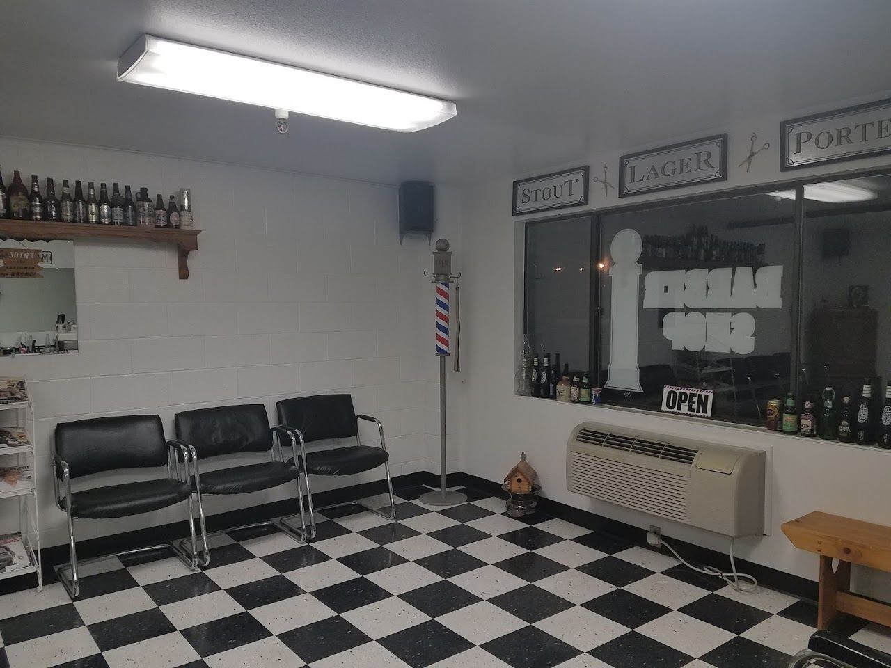 Inside Garrity Barber Shop in Nampa, with classic barber chairs and a black and white checkered floor