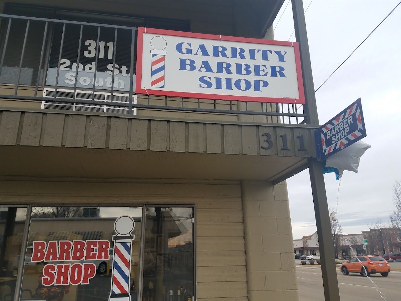 The Garrity Barber Shop sign and barber pole above the 311 2nd Street entrance