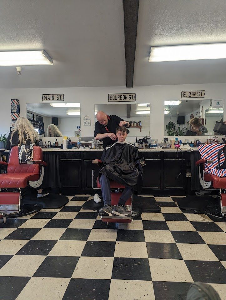 Barber stations and the black and white checkered floor inside Garrity Barber Shop