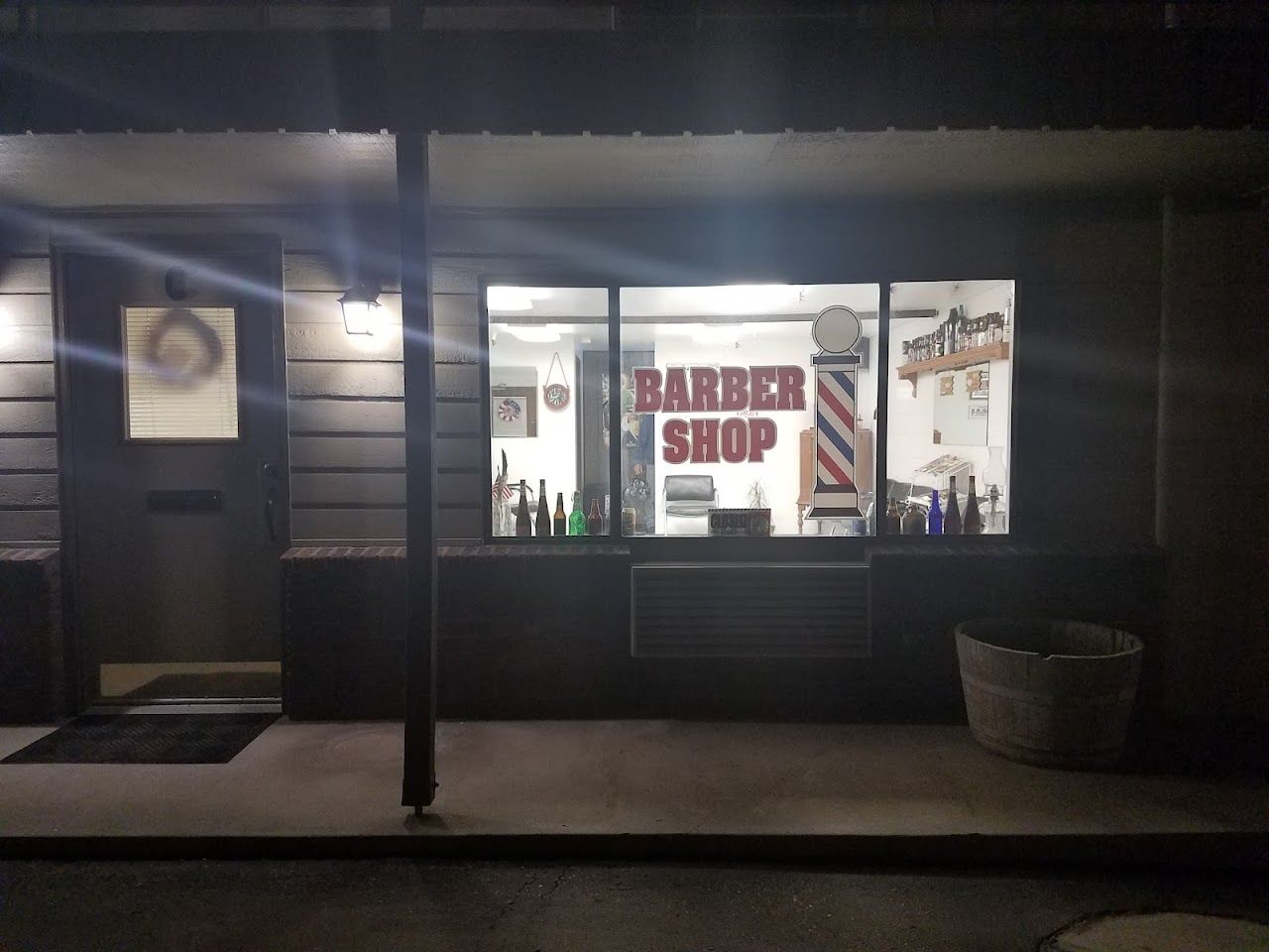 The Garrity Barber Shop storefront on 2nd Street in Nampa at dusk